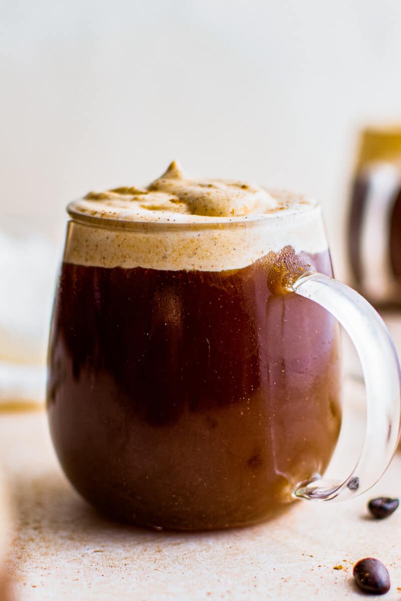 clear mug with pumpkin cold foam coffee