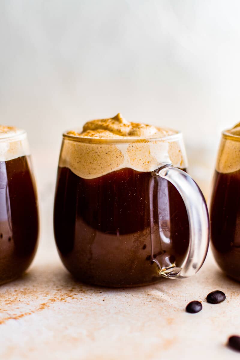 3 clear mugs with pumpkin cold foam coffee