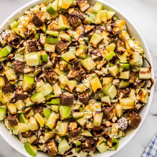 white bowl filled with snickers apple salad