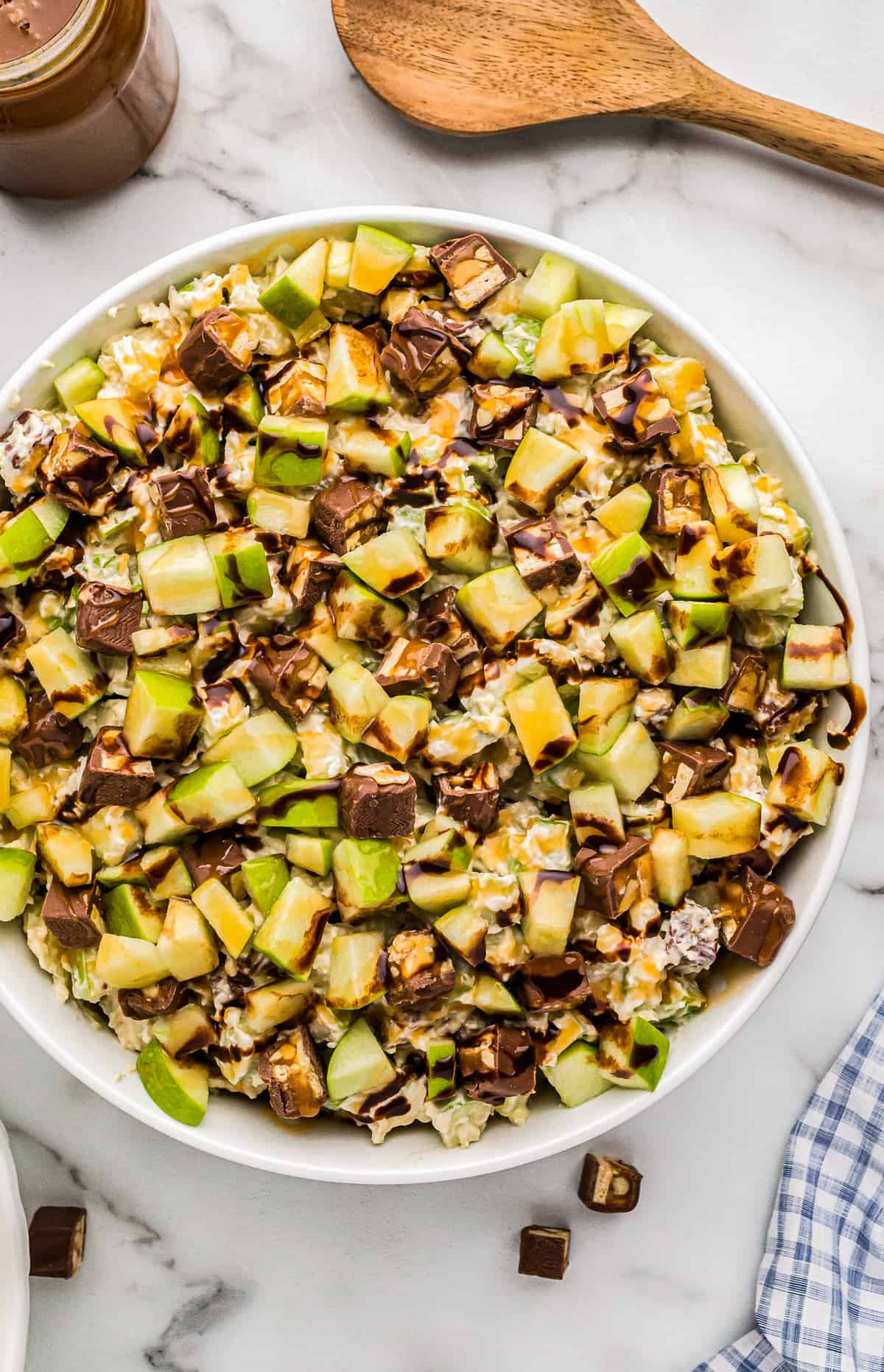 white bowl filled with snickers apple salad