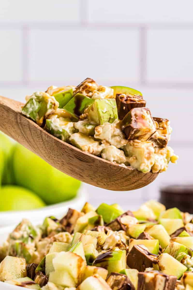 wooden spoon lifting up snickers apple salad