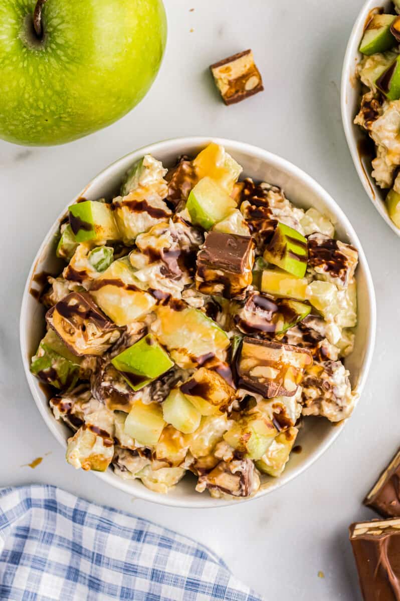 small bowl with snickers apple salad with chocolate sauce