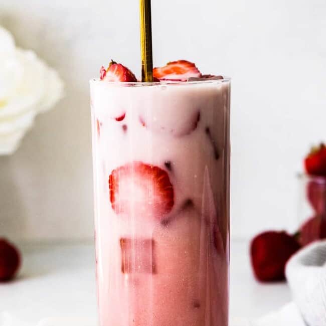 starbucks pink drink with fresh strawberries with gold straw