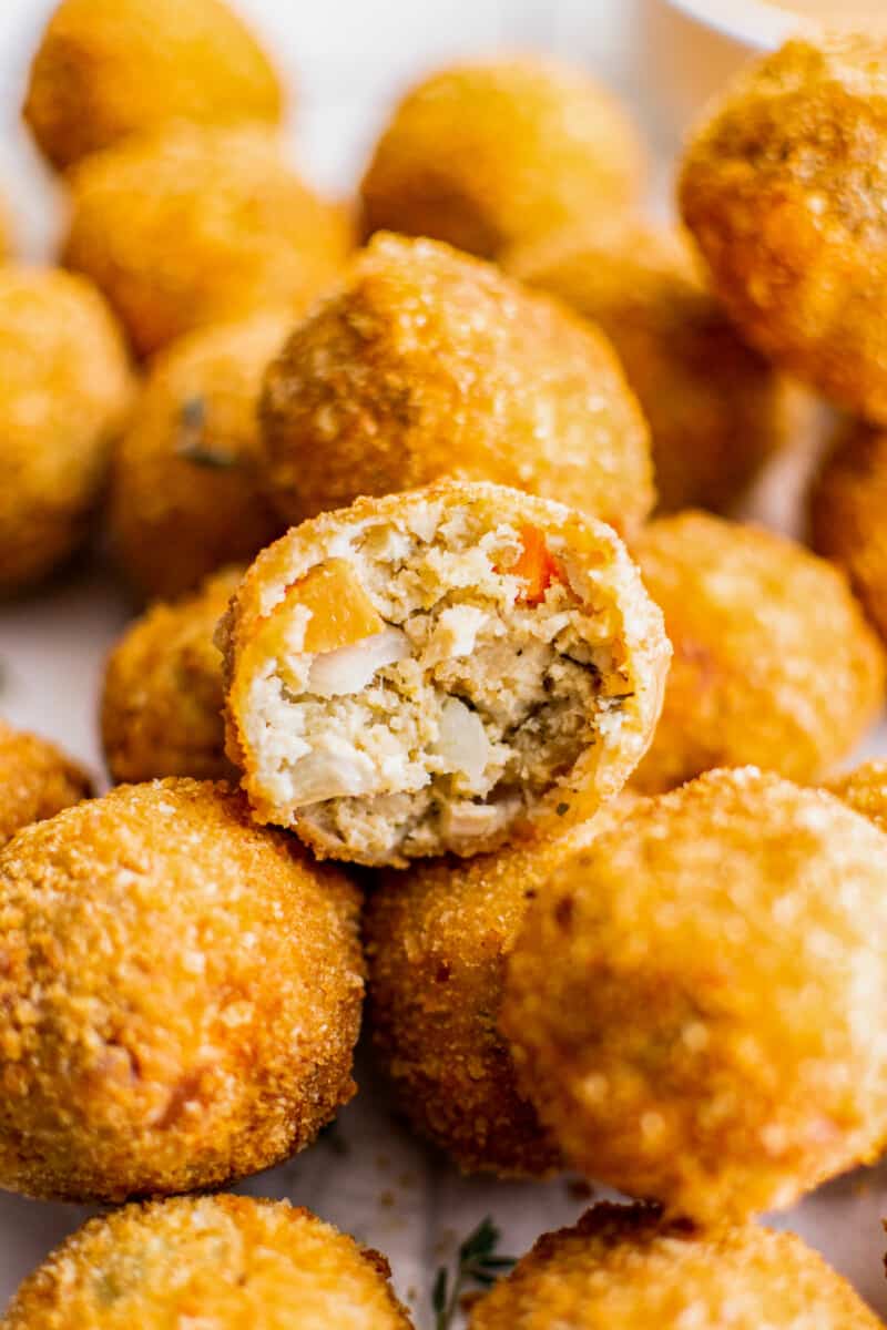 up close inside of turkey croquette cut in half on top of full croquettes