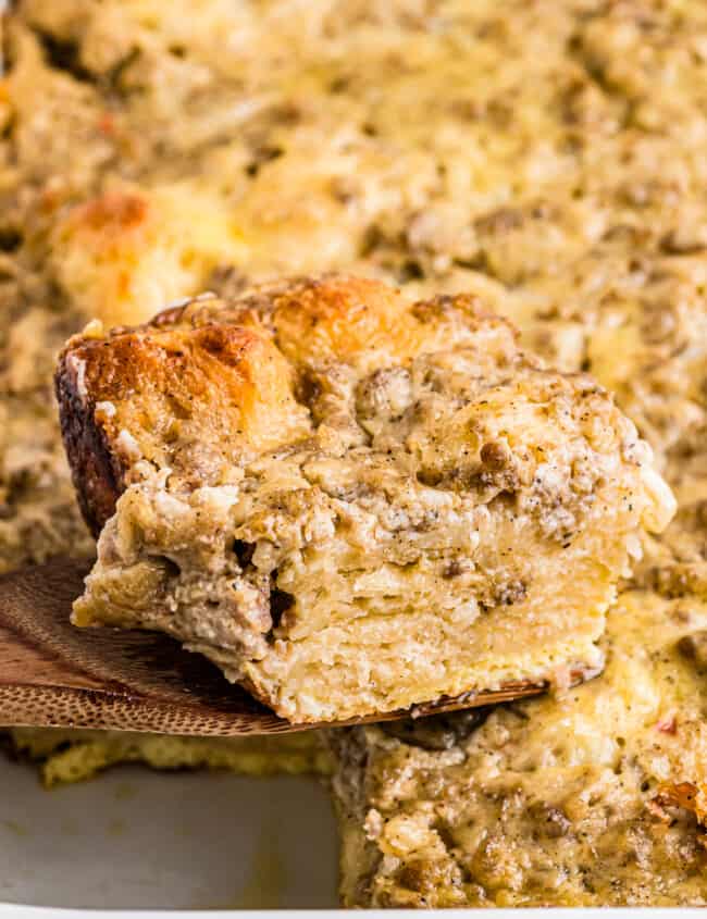 piece of biscuits and gravy casserole on a wood spatula