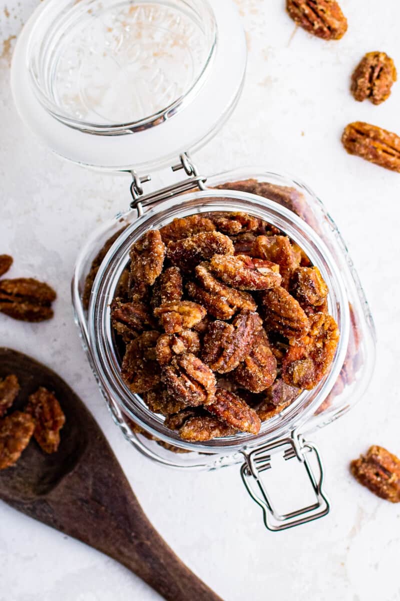 overhead image of candied pecans in a glass container