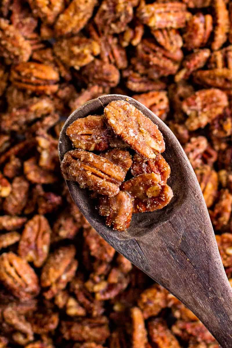 wooden spoon with candied pecans in it