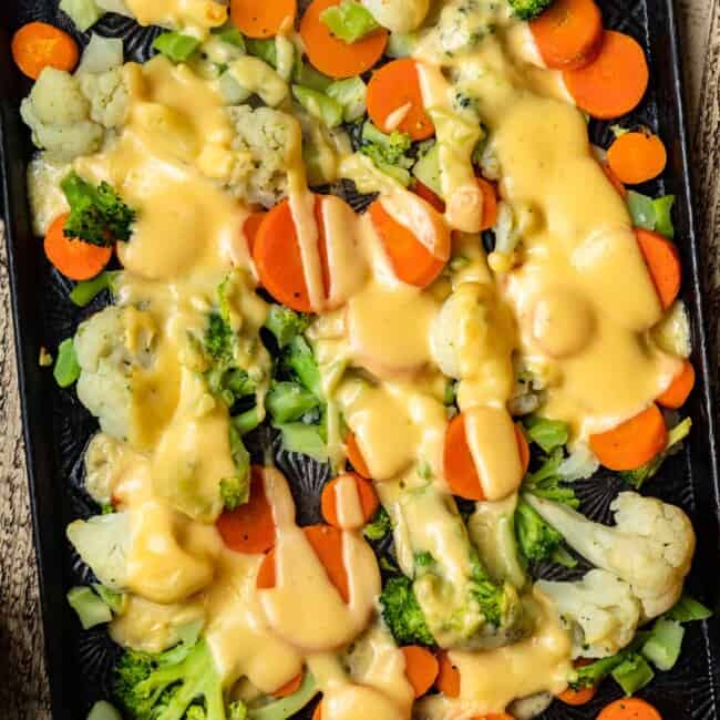 cheesy roasted vegetables on sheet pan