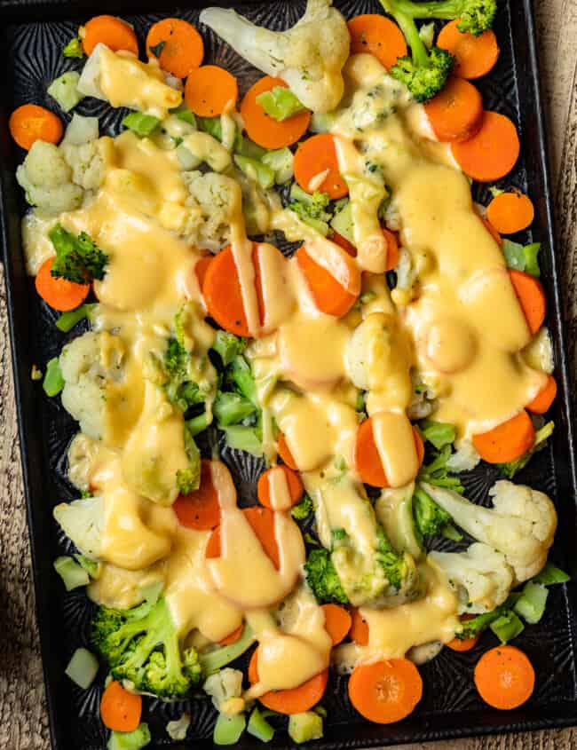 cheesy roasted vegetables on sheet pan