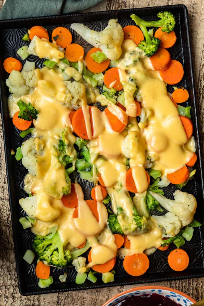 cheesy roasted vegetables on sheet pan