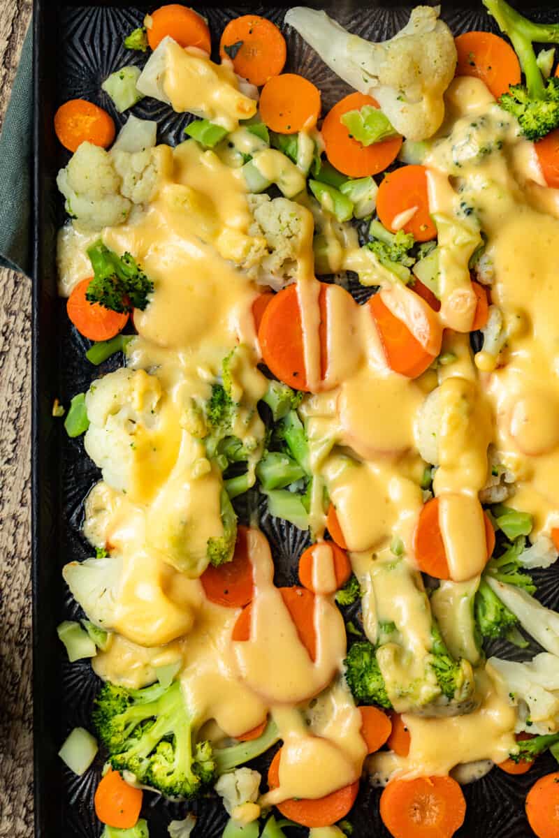 up close cheesy roasted vegetables on sheet pan