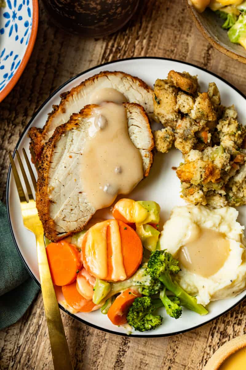 plate with thanksgiving sides and cheesy roasted vegetables
