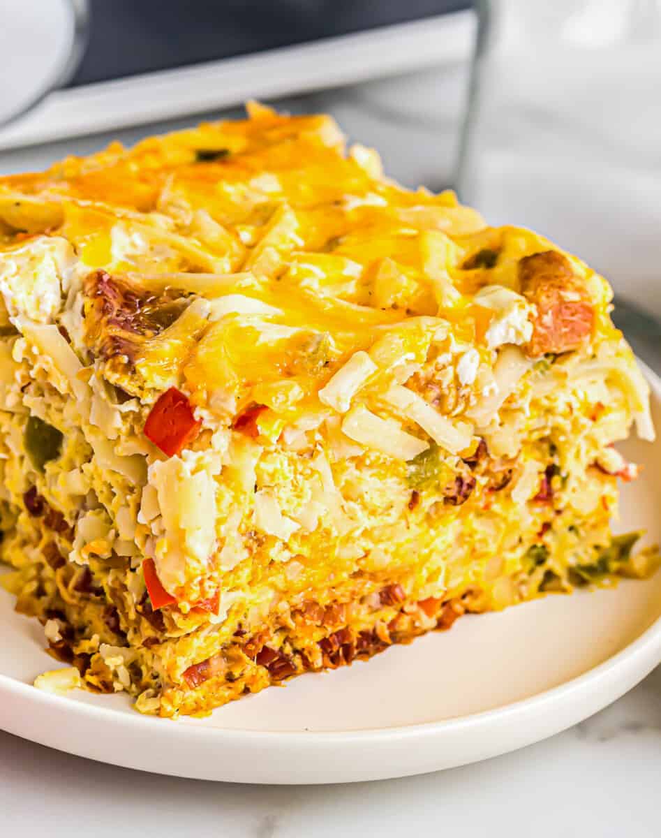 close up image of slice of breakfast casserole on a white plate