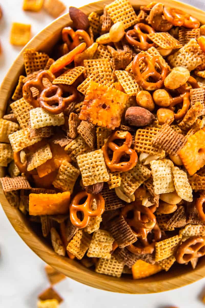 close up overhead image of chex mix in a wood bowl