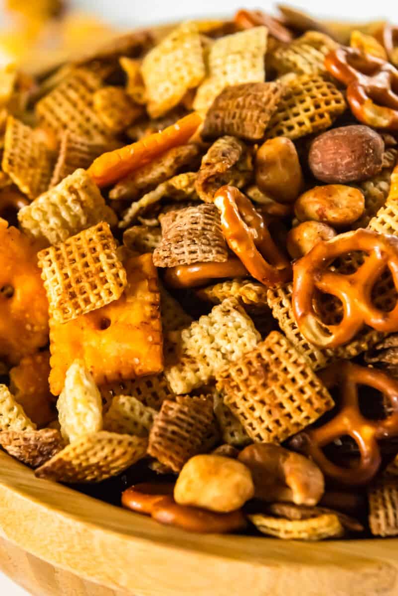 close up image of chex mix in a wood bowl
