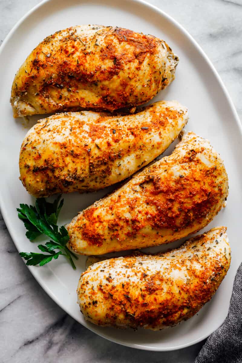 crockpot chicken breasts on white platter