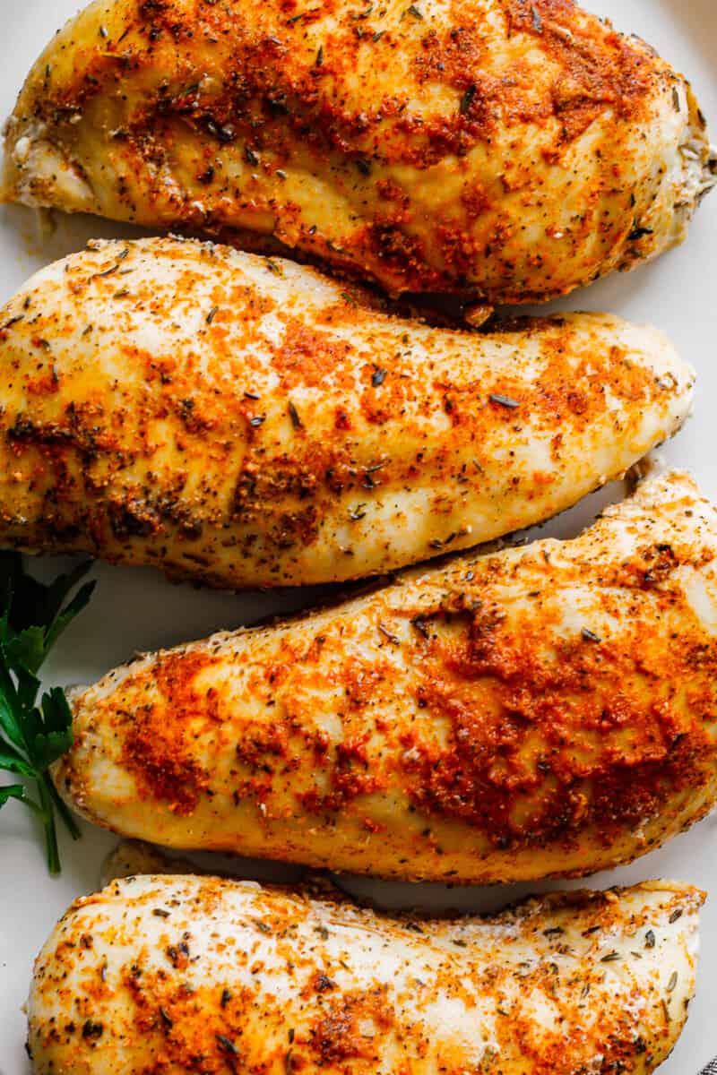 up close crockpot chicken breasts on white platter