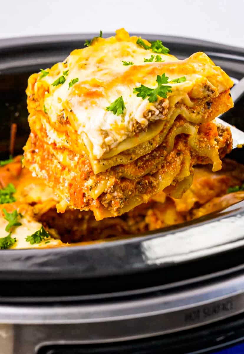 lifting up slice of lasagna from crockpot