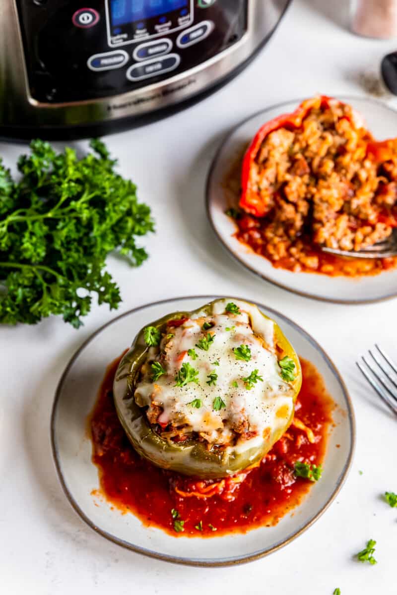 two plates with crockpot stuffed peppers