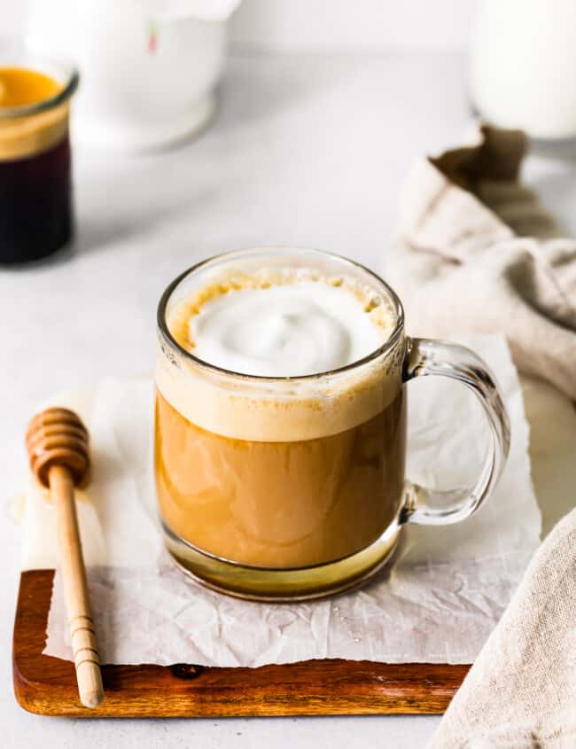 honey almond milk flat white in a clear glass mug