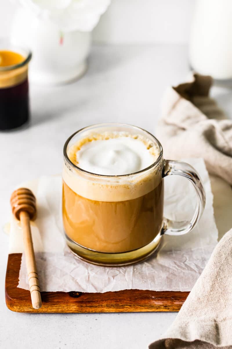 honey almond milk flat white in a clear glass mug