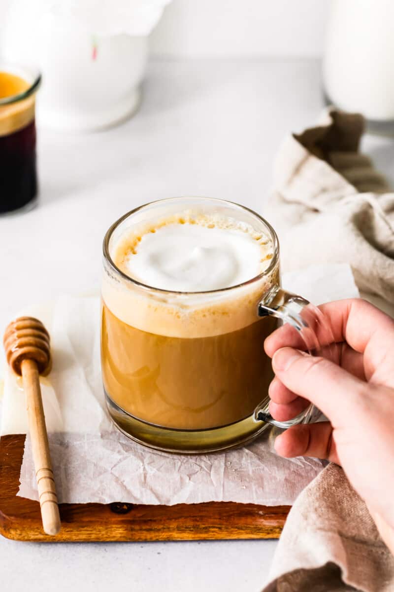 honey almond milk flat white in a clear glass mug