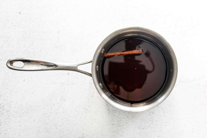brown sugar syrup in a saucepan with a cinnamon stick