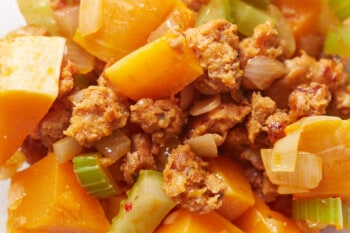 close up of butternut squash mixed with veggies and italian sausage.