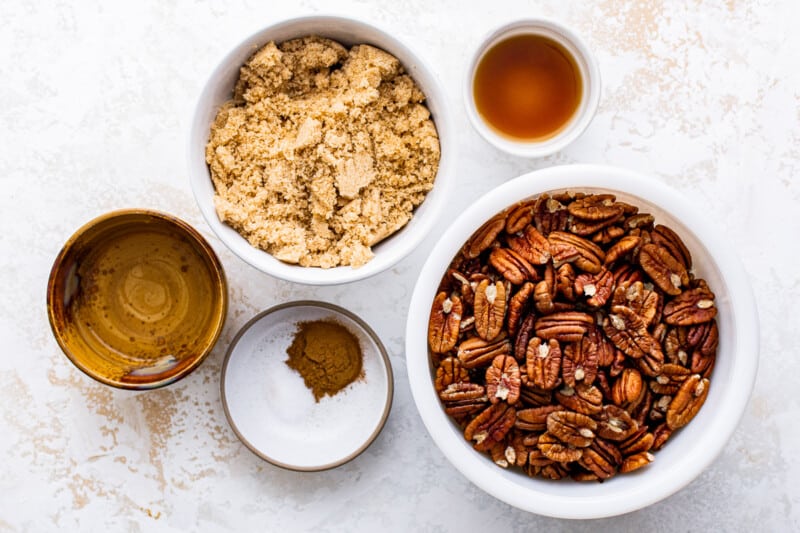 overhead image of ingredients for candied pecans in bowls