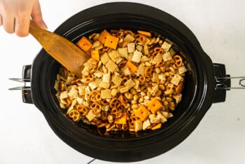 chex mix ingredients in a crock pot after mixing