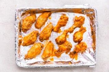 buffalo chicken wings on a baking sheet lined with foil before baking