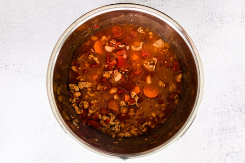 ground turkey, vegetables, stock, tomatoes, beans, and spices in instant pot