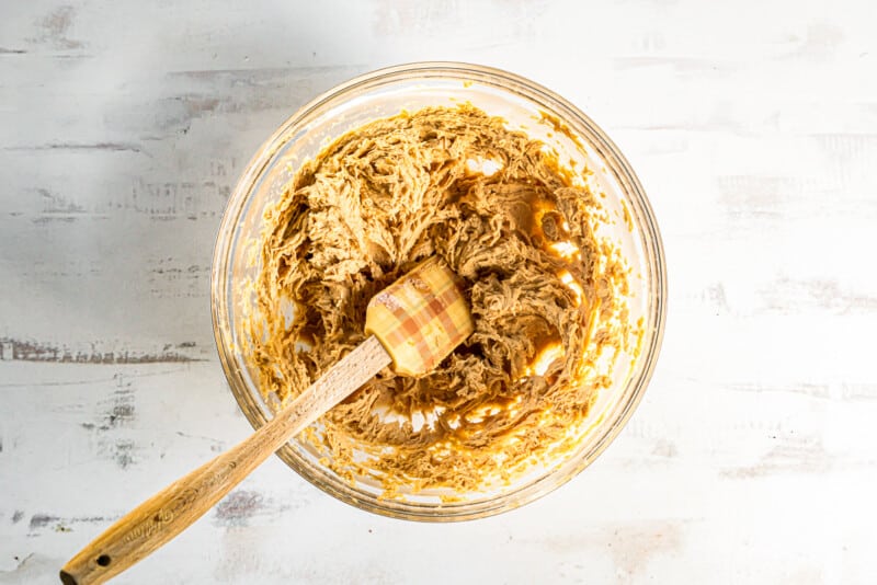 peanut butter pie filling in glass bowl with a spatula