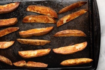 potato wedges on a baking sheet after baking