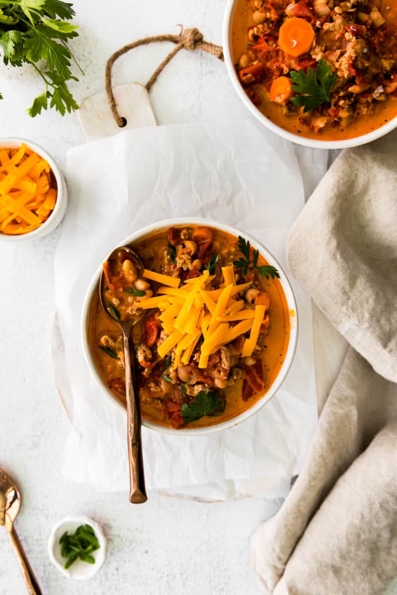 overhead image of turkey white bean chili with a spoon