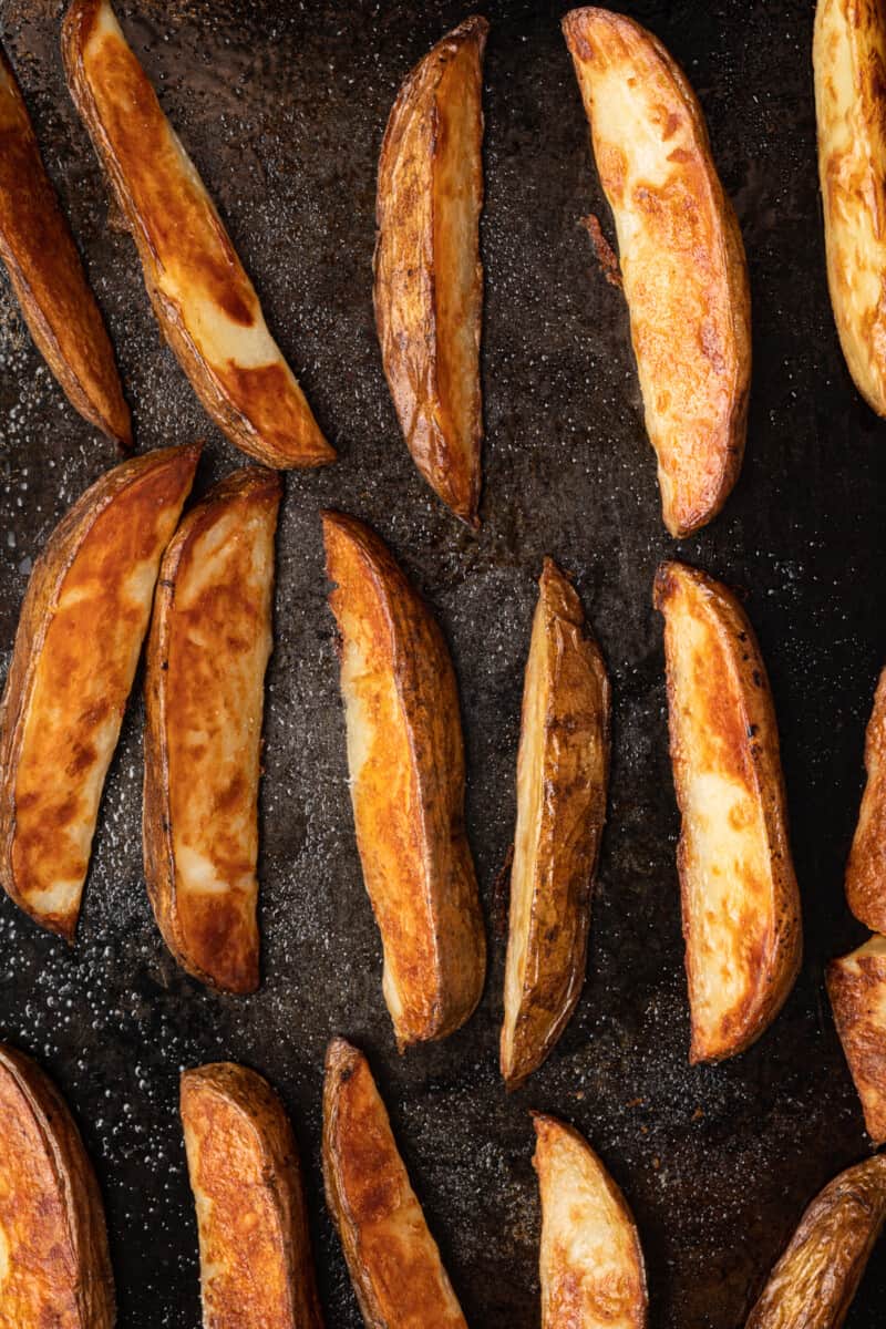 potato wedges on a baking sheet after baking