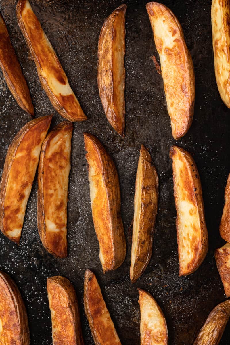 potato wedges on a baking sheet after baking