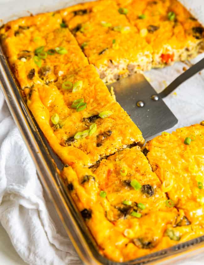 sausage breakfast casserole cut into squares with a spatula