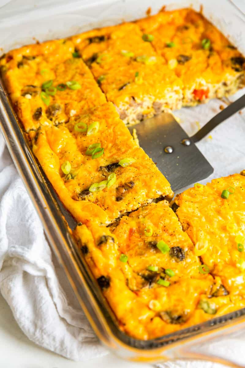 sausage breakfast casserole cut into squares with a spatula