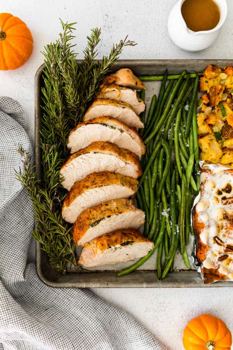 sheet pan thanksgiving dinner with sliced turkey breast