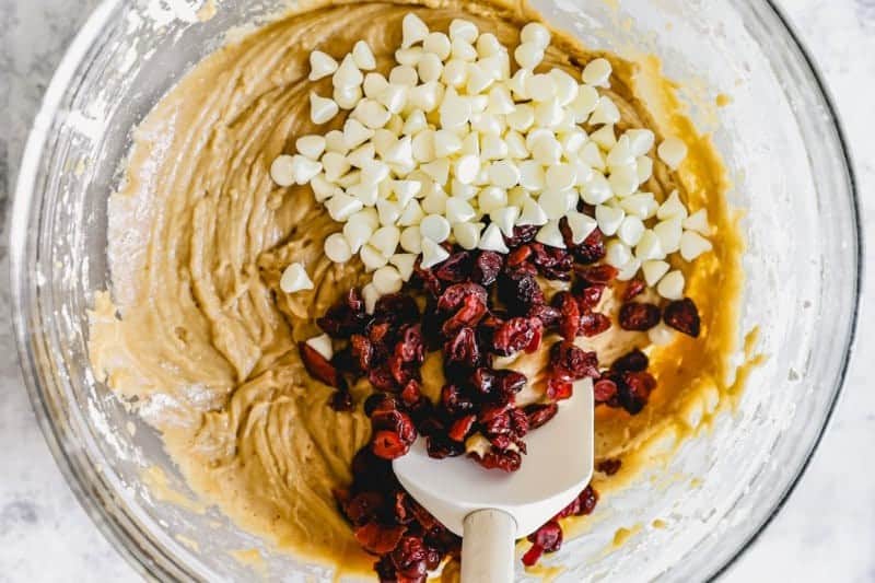 Adding cranberries and white chocolate chips to the bliss bar batter.