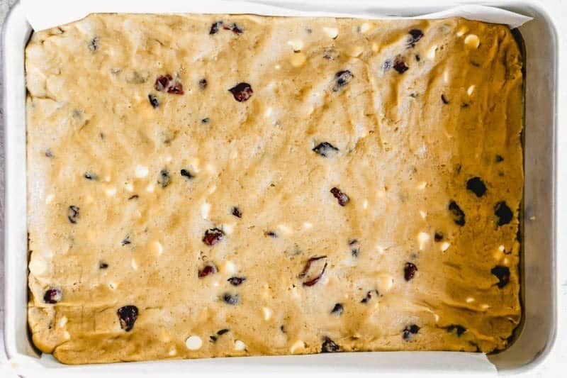 Spreading the batter into the prepared baking pan.