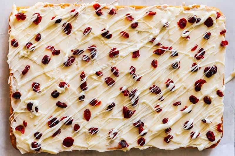 Topping the bars with dried cranberries and melted white chocolate. 