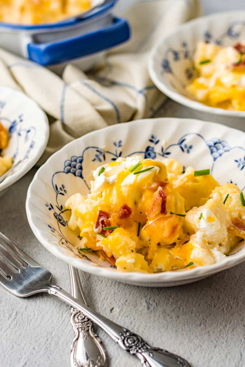 loaded cauliflower bake in a decorative white bowl with a fork.