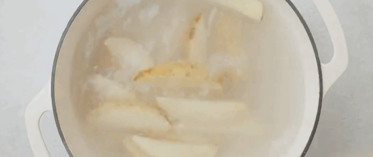 Boiling potato wedges. 