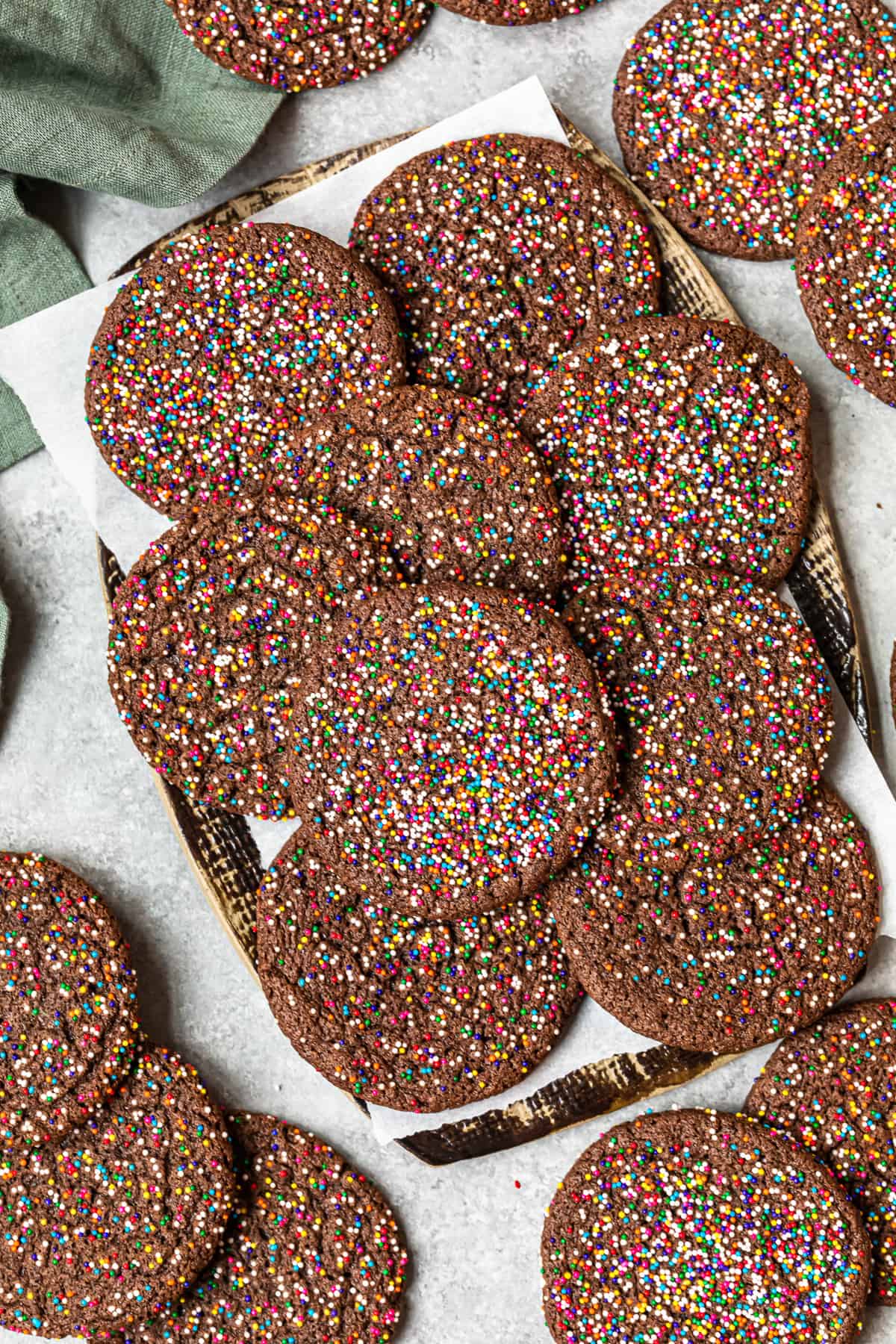 Chocolate butter cookies with sprinkles on a baking sheet.