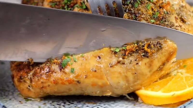 close up of a knife slicing through turkey