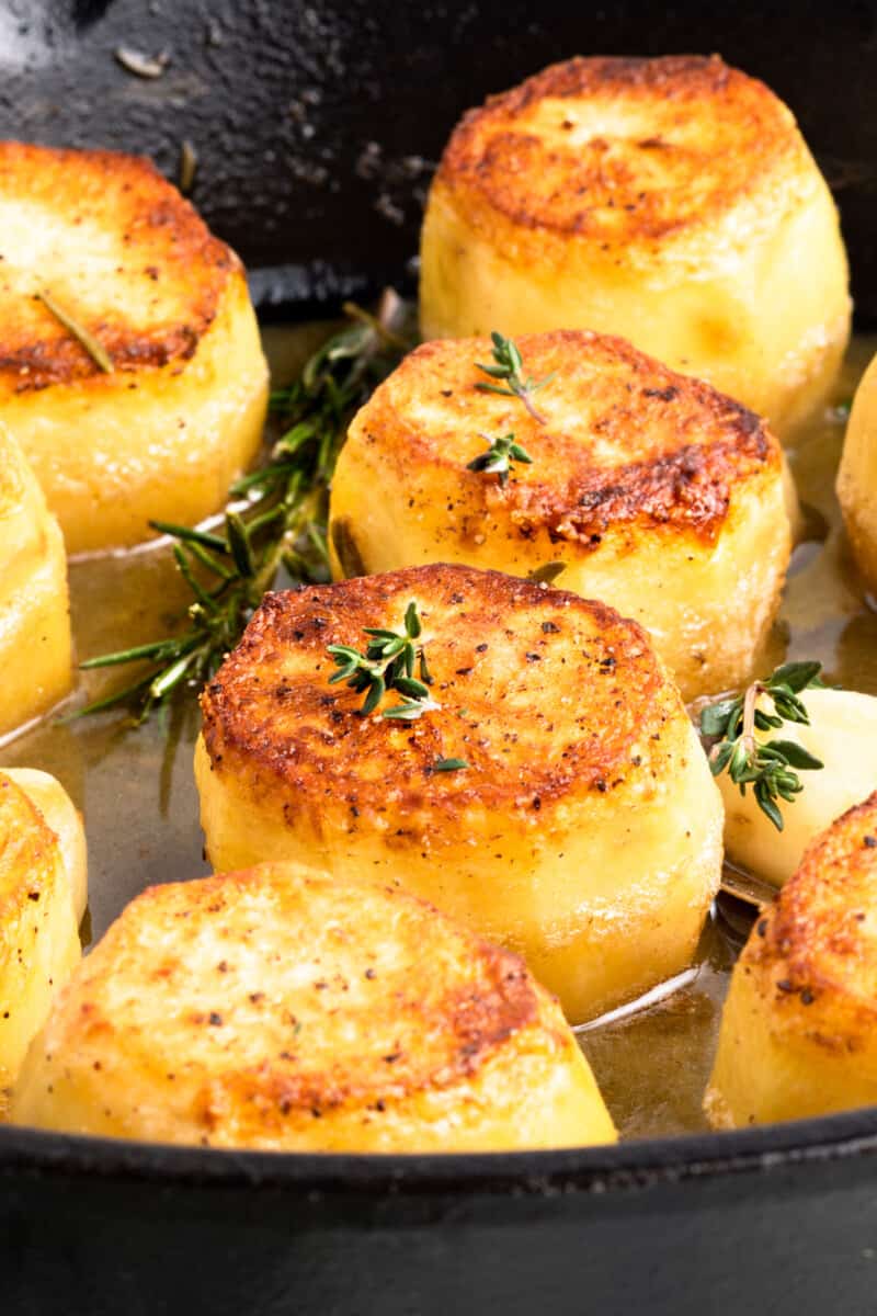 close up image of fondant potatoes in a skillet