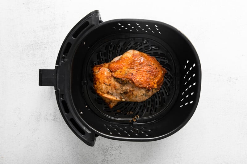 garlic rosemary turkey breast in air fryer basket after cooking