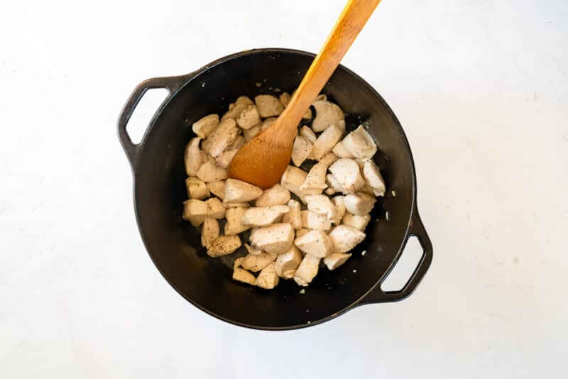 chicken for chicken and dumplings in a pot with a wood spoon